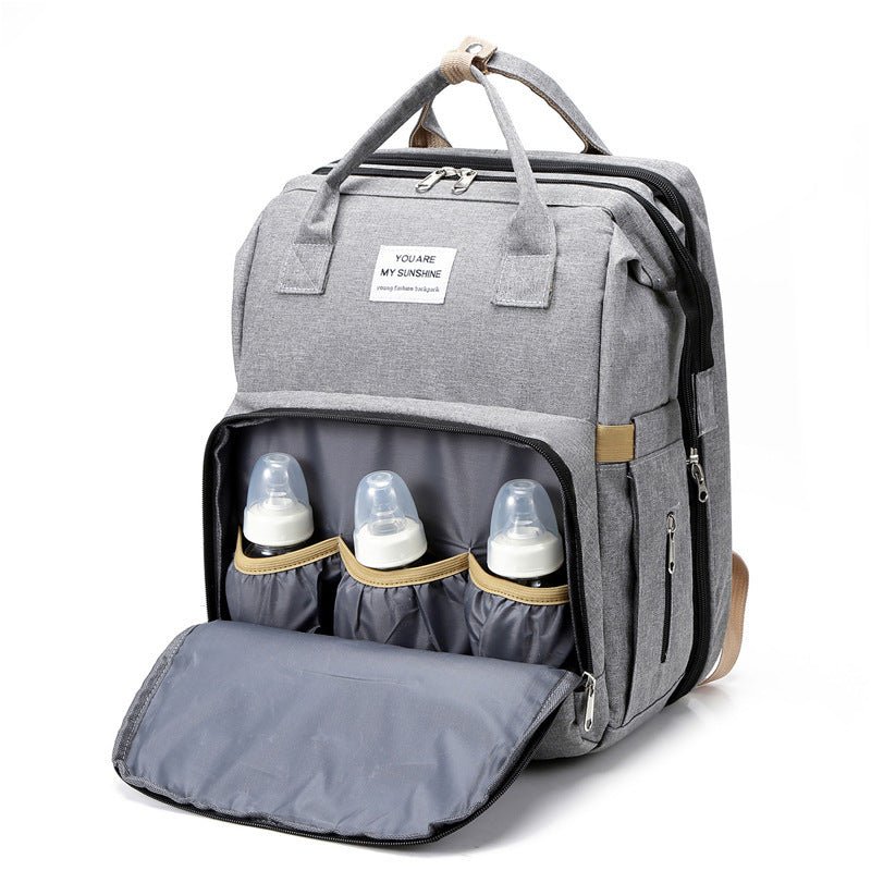 sac-a-langer-multifonction-gris-biberons-lit-dépliable-must-have-boutique-joie-de-bébé